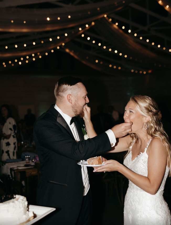 bride and groom feeding each other cake